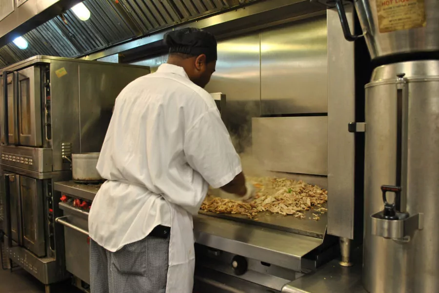 Person cooking on flat top