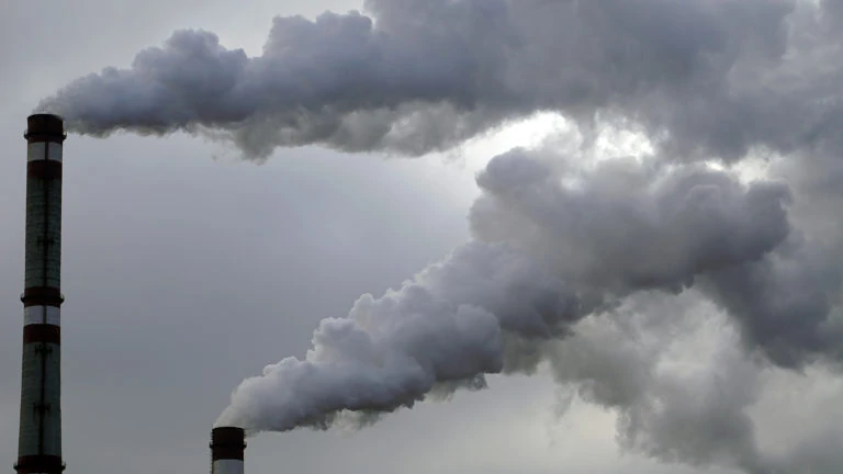 industrial chimneys emits toxic pollutants into the sky polluting the environment