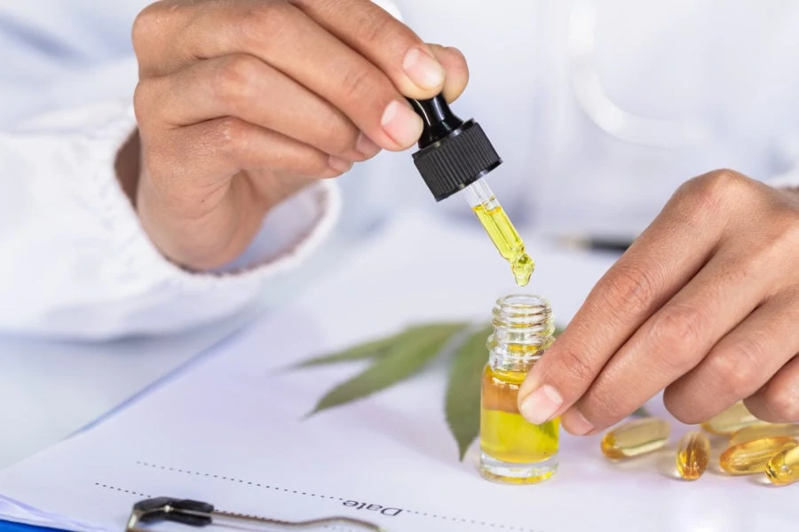 Researcher using a dropper with yellow liquid