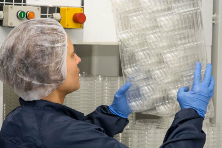 technician inspecting plastic packaging details